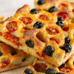 Close up of focaccia pugliese with olives and tomatoes
